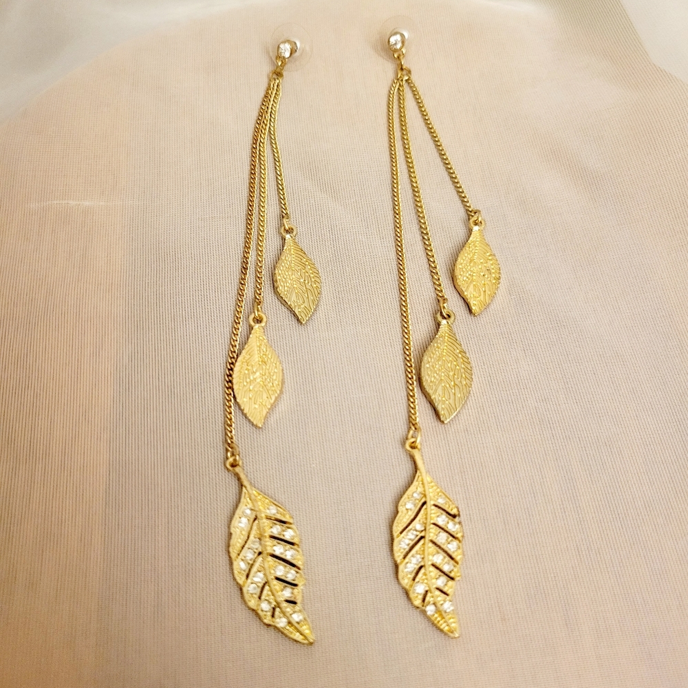 Gold tone dangle long earrings with leafs